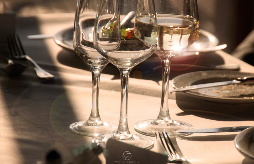 Wine glasses that bounce the light with cutlery and white table cloth