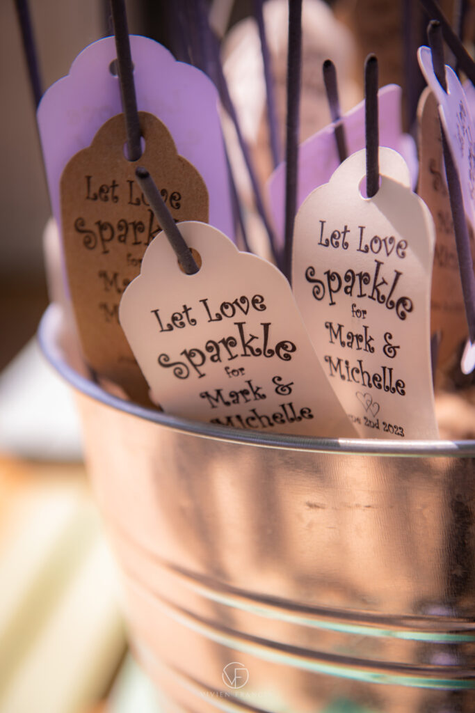 Close up of sparkles with written messages from bride and groom in a tin bucket