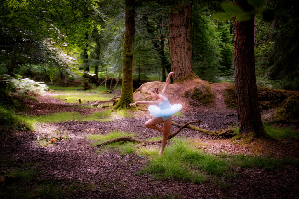 Girl in the middle of a dark mystical forest, doing a ballet dance in a blue tutu